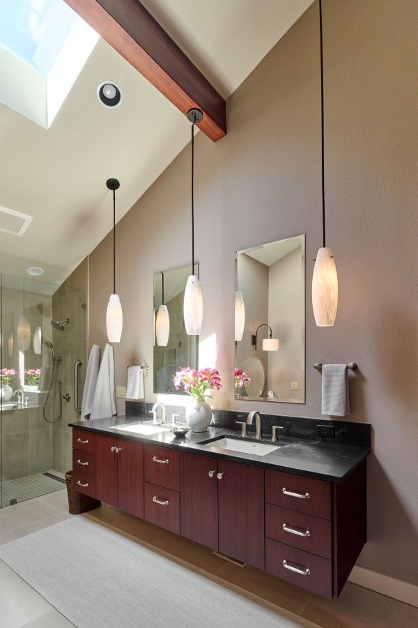 With natural light, rich wood cabinetry, and elegant pendant lighting, this spa-inspired bath is the perfect daily retreat.
