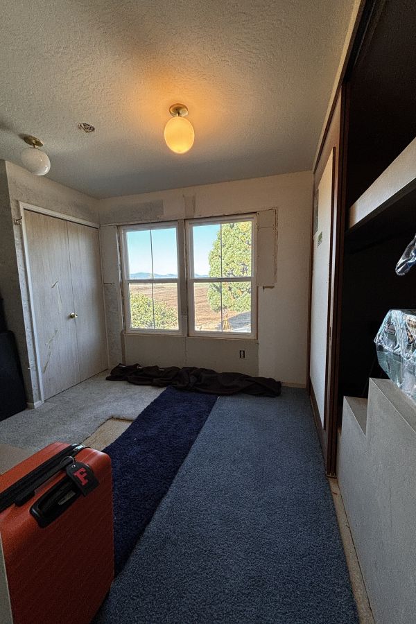 This underutilized storage space was remodeled into a gorgeous primary bathroom by Powell Construction.