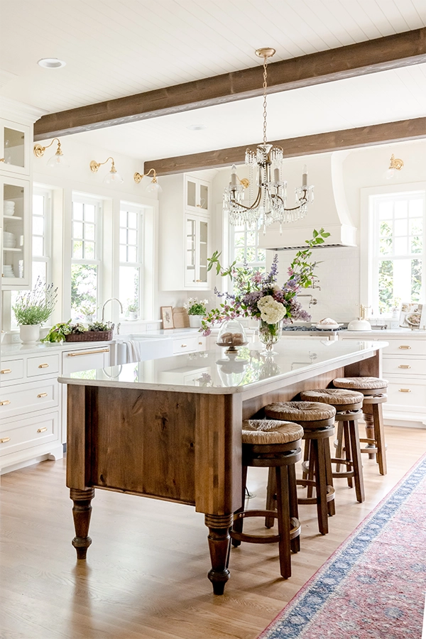 Photo of an English Farmhouse Kitchen addition with wood island and white quartz countertop.