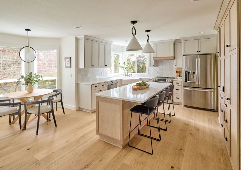 This beautifully remodeled kitchen is filled with classic, natural tones. It complements and enhances the material selections in the adjacent family area.