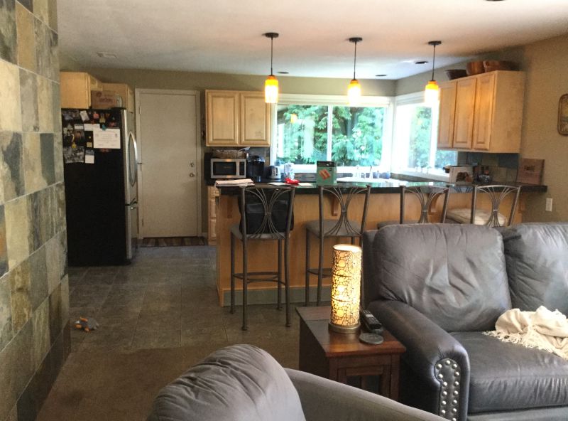 Photo of la living room and kitchen before the remodel that made it bright, open, and brought a cohesive feel to the entire first floor.