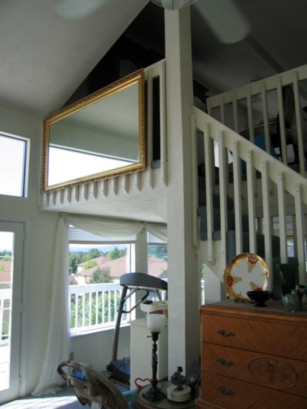 Staircase and loft area prior to a remodel that relocated the staircase and opened the kitchen to the main living space.