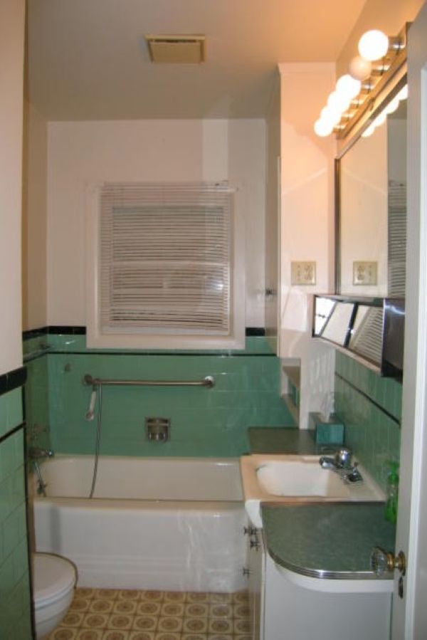 1930's bathroom with green plastic wall tile, prior to remodel by Powell Construction.