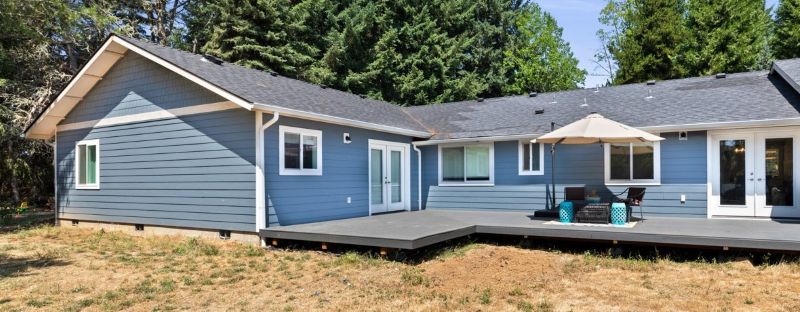 Home's back exterior with new wrap around porch post addition.