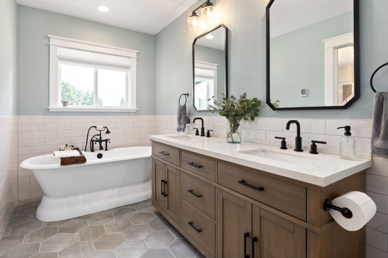 Primary Ensuite bath in modern farmhouse style with warm wood vanity, matte black fixtures and freestanding bathtub.