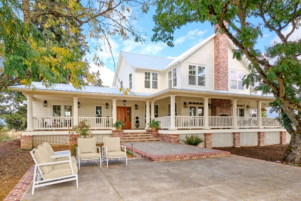 Gorgeous exterior photo of our Southern Farmhouse Style addition with large wrap around porch.