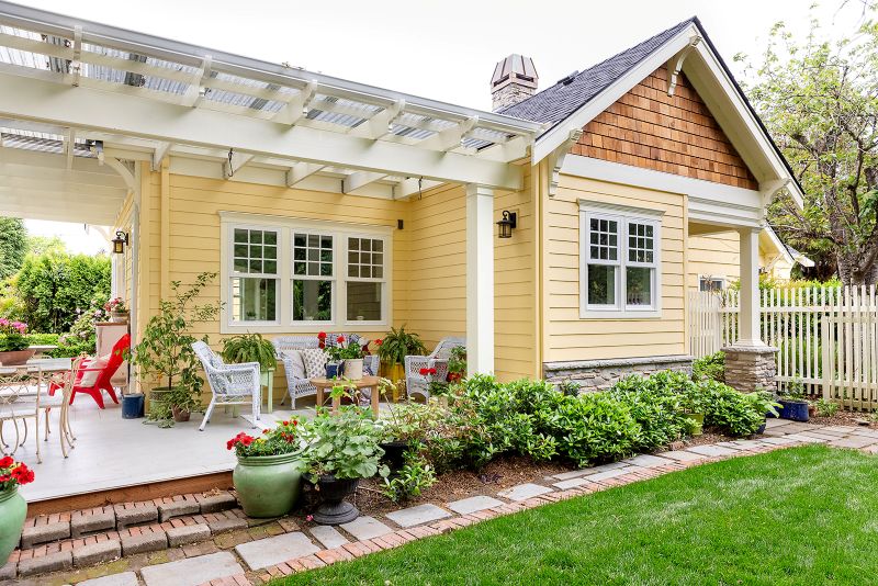 Angled view of covered porch and exterior view of kitchen addition.