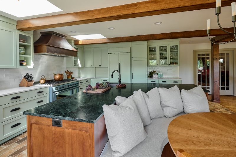 Curved banquette seating built into the back of the kitchen island.