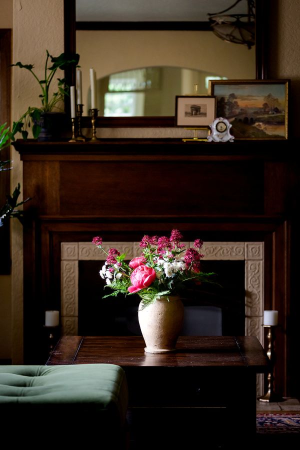 Gorgeous woodworking on mantle and fireplace surround highlights the era of this 1930's home.