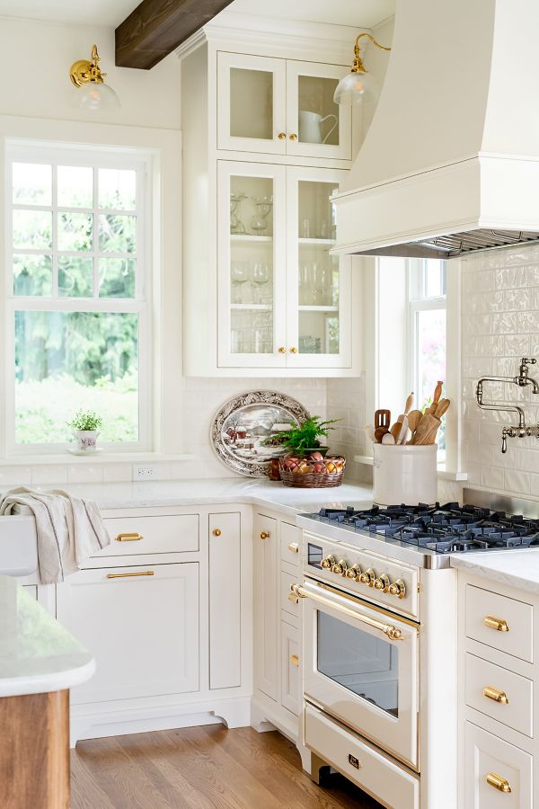 View from the breakfast nook toward the kitchen range and sink, with garden views through the window.