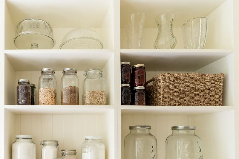 Butler’s pantry with organized canning storage shelves.