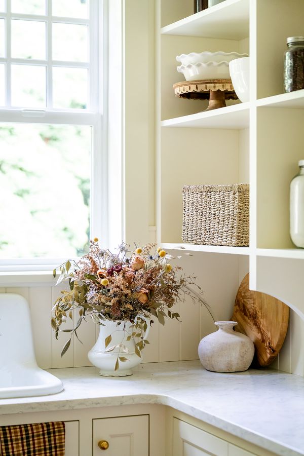 Open shelves providing stylish and functional storage solution in butler&#039;s pantry.