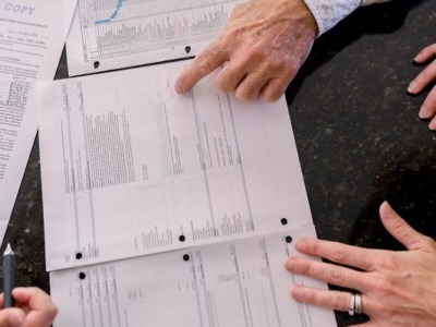 Photo of designer and customer reviewing estimate and schedule with our customer.