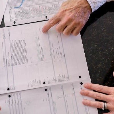 Photo of designer and customer reviewing estimate and schedule with our customer.