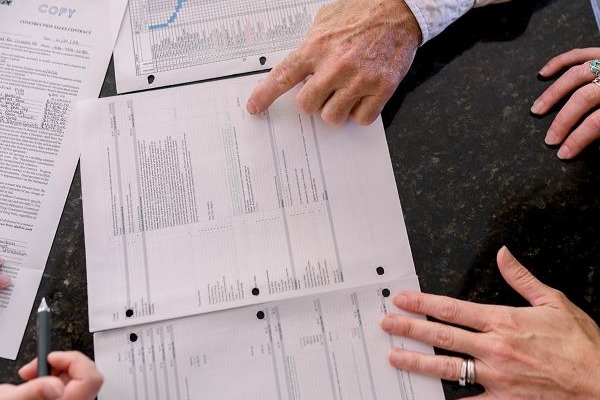 Photo of designer and customer reviewing estimate and schedule with our customer.