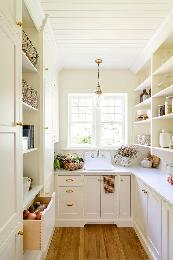 Butler’s pantry in English cottage style with custom cabinetry, open shelving, and vintage-inspired details.