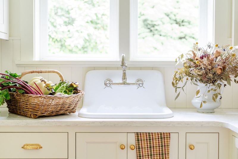 Butler’s pantry with garden sink and storage, featuring functional prep area for washing produce and canning supplies.