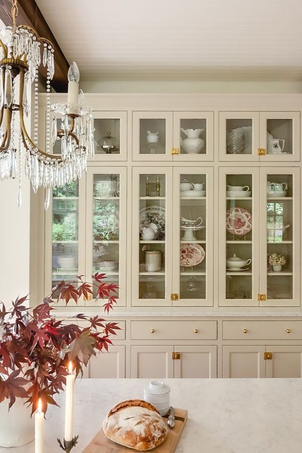 Custom built in hutch cabinetry with crystal chandelier in foreground.