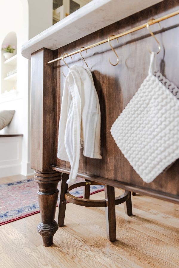 This brass rod was integrated into the end of the island, near the sink and range, providing a convenient place to hang potholders and kitchen towels.