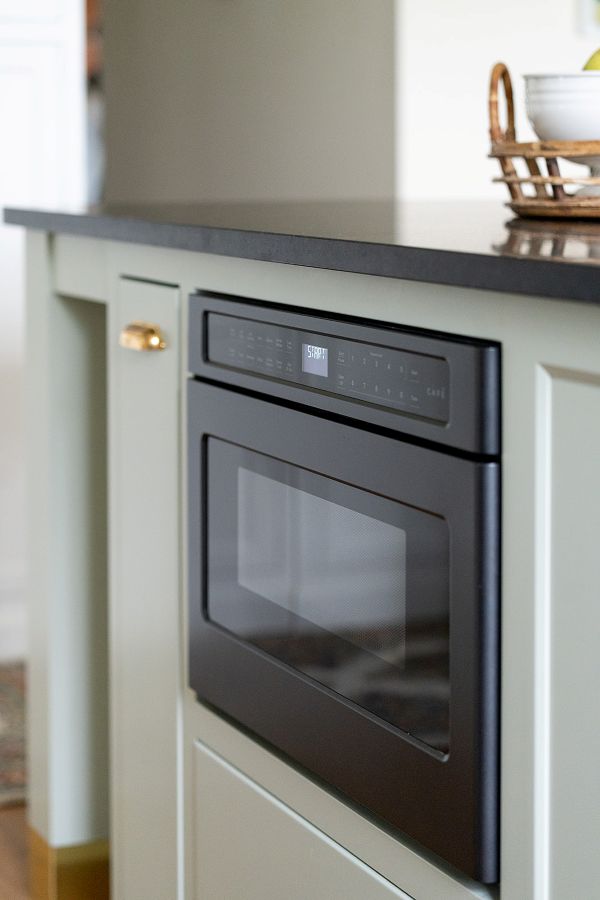 Drawer-style microwave built into kitchen island.