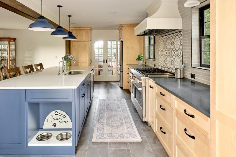 Pet feeding station built into the end of the kitchen island, using countertop quartz remnant.