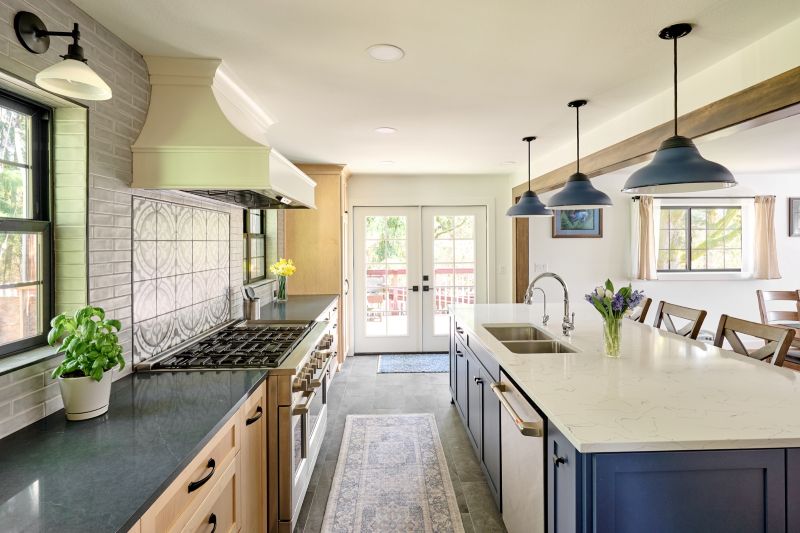 Dishwasher and sink are included in the island cabinetry of this gorgeous navy and maple kitchen remodel.