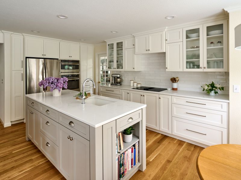 Built-in bookcase on the end of this kitchen island holds cookbooks.