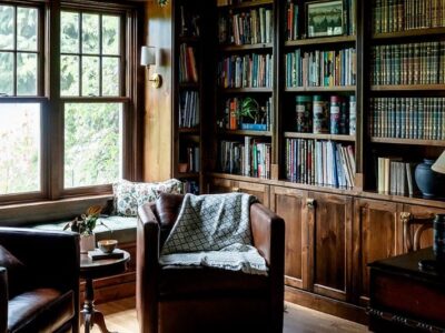 Study with built-in shelves in mahogany shade wood stain.