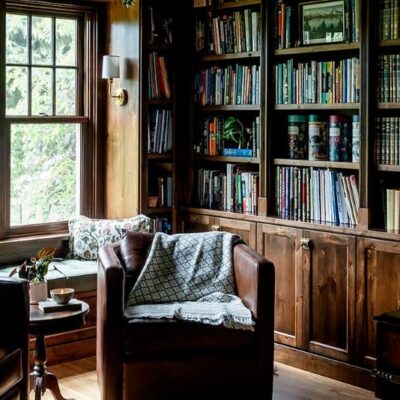 Study with built-in shelves in mahogany shade wood stain.