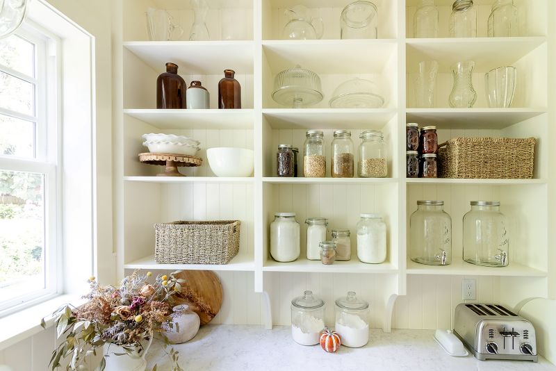 Open pantry shelving with quartz countertop below, providing stylish kitchen storage and workspace.”