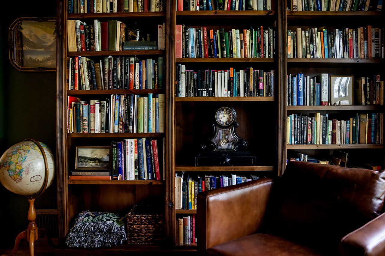 This English Cottage study features built in mahogany look book shelves. Before its remodel, this space was a dining room.
