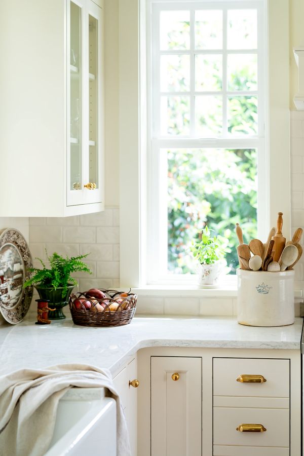 Custom kitchen cabinet pullout with organized knife storage and utensil dividers, conveniently located next to the stove for easy cooking access.