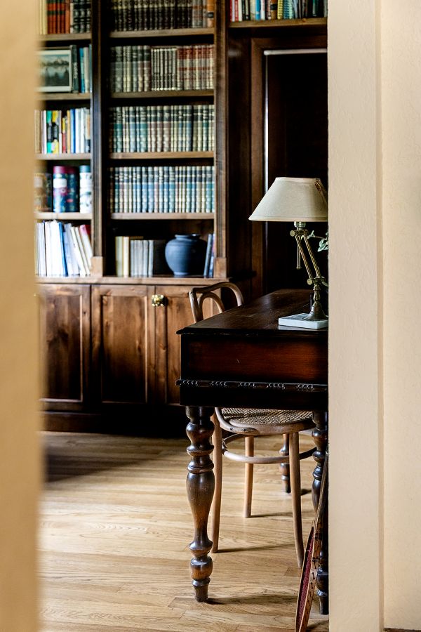 View from the living room into study, shows vintage desk and built-in sheving.