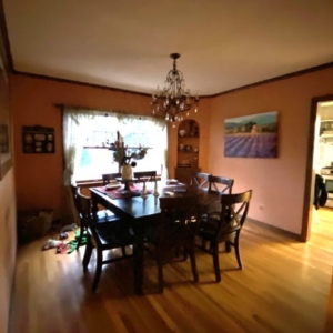The study, prior to its remodel, was this dining room with coral walls and a crystal chandelier suspended over the table.