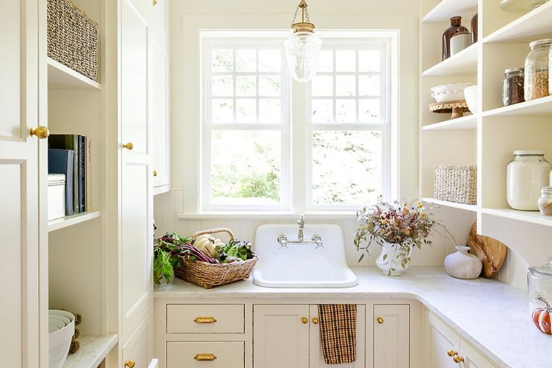 Window overlooking garden, bringing natural light and a view of greenery into the space.