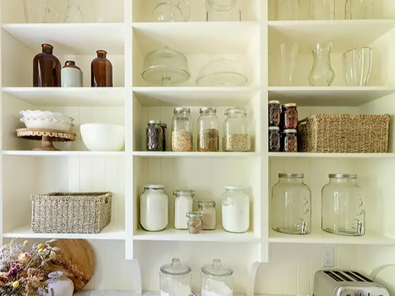 Open shelves in butler's pantry provide storage for vases, canned goods, and cake stands.