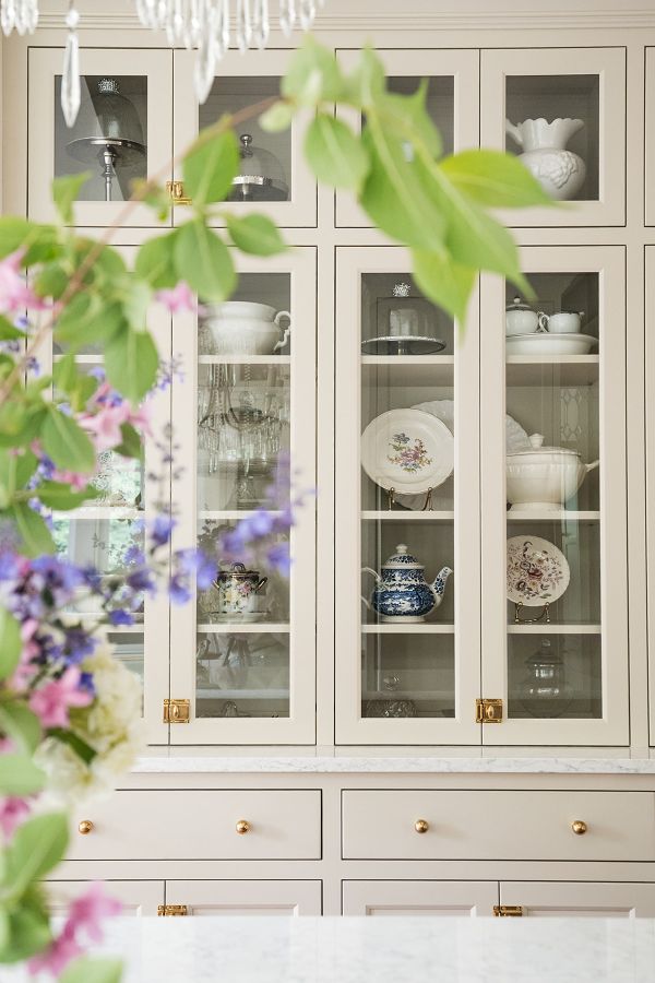 Greige, glass-front built-in hutch