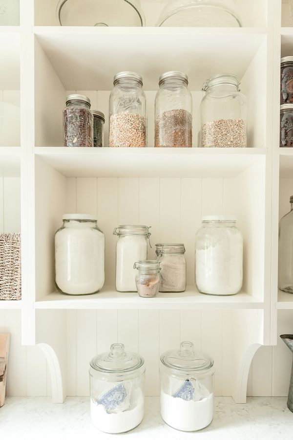 Open-pantry-shelving White open shelving stores jars and canisters