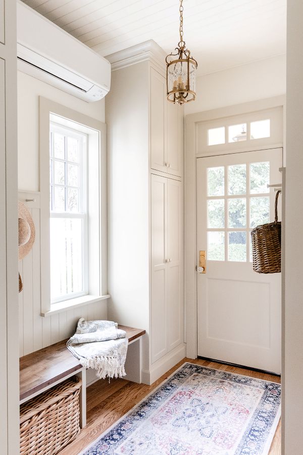 Entryway from backyard garden into kitchen with gorgeous greige wainscotting and cabinetry