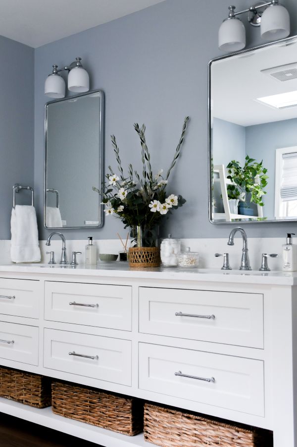 Angled view of white custom vanity, accented with brilliant polished chrome accents.