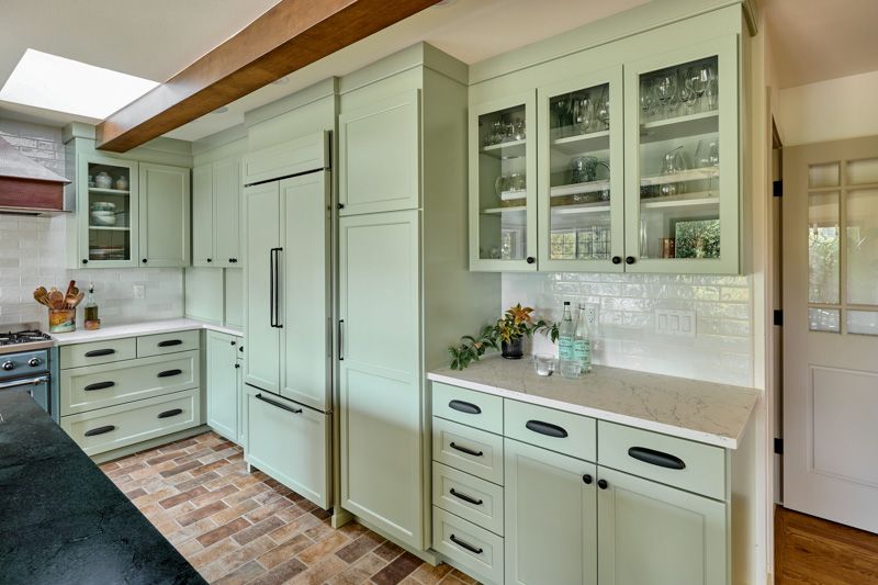 This built-in beverage station with glass front cabinetry helps to break up the long run of solid cabinetry.