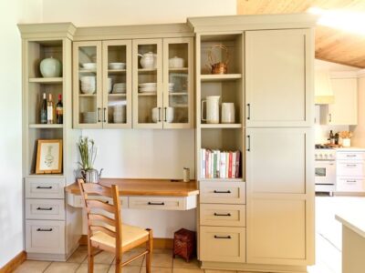 Integrated hutch serves to store dishware and provides desk space for these homeowners.