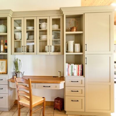 Integrated hutch serves to store dishware and provides desk space for these homeowners.