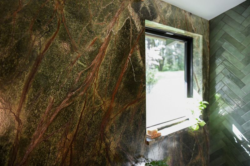 Green rainforest marble shower walls with window.