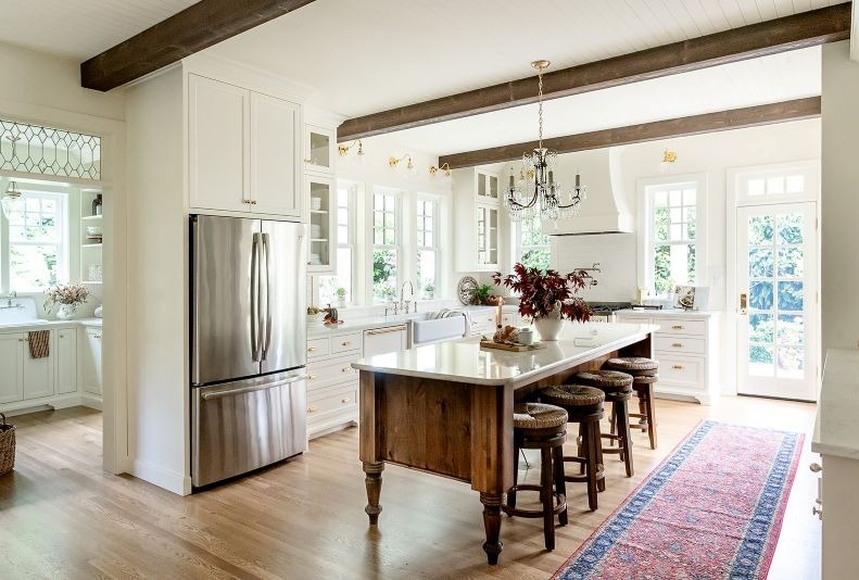 Open-concept English cottage kitchen with traditional details, adjacent to a quaint butler’s pantry.